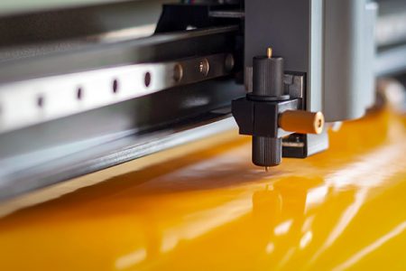 Cutting plotter close-up. The process of cutting a vinyl film.